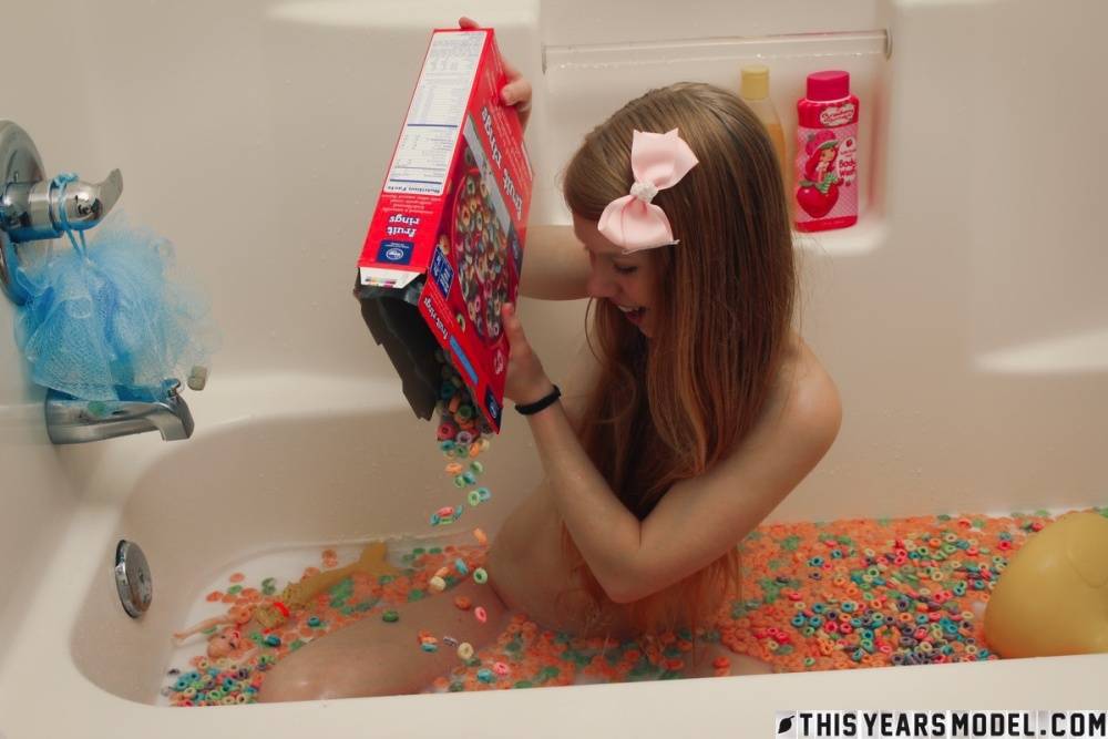 Young looking girl Dolly Little empties a box of cereal into her bathwater - #8