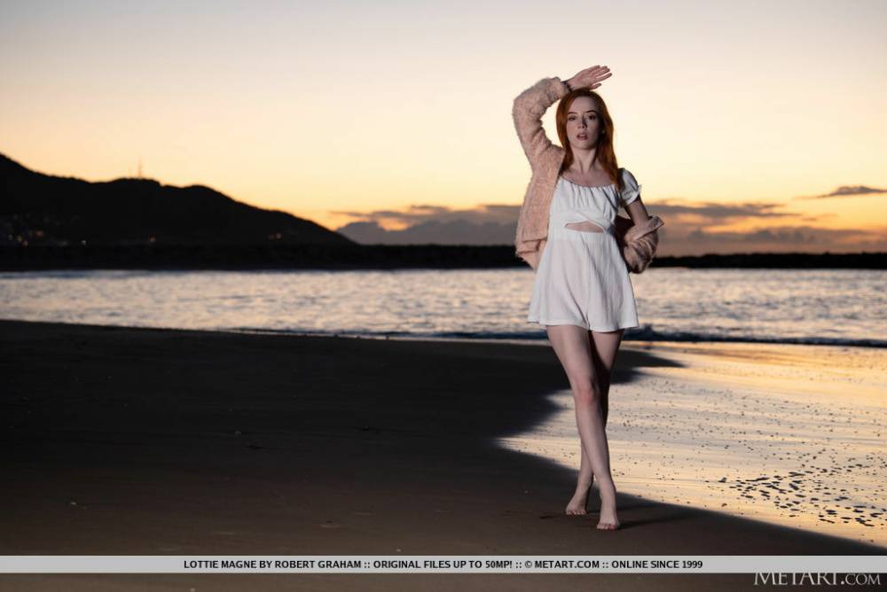 Young redhead Lottie Magne gets totally naked after walking a beach at sunset - #15