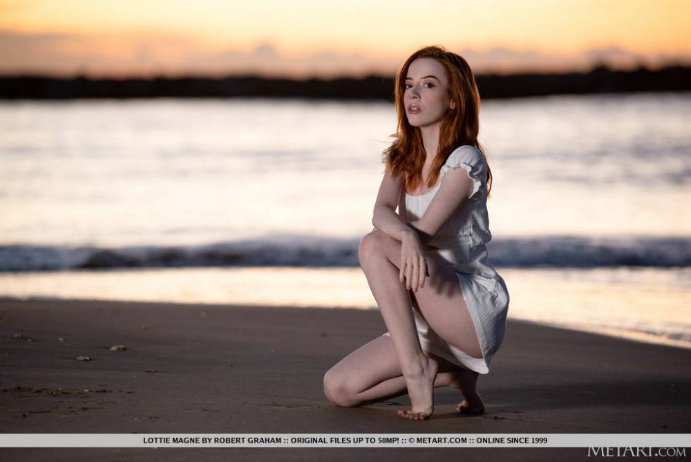 Young redhead Lottie Magne gets totally naked after walking a beach at sunset - #12