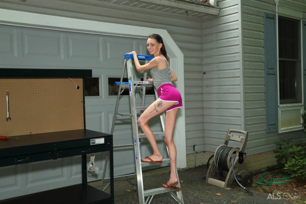 Skinny teen Aria Haze gets totally naked on a workbench out in a driveway - #12
