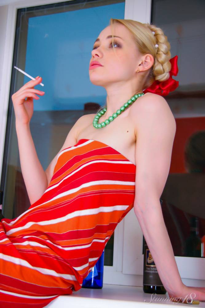 18 year old blonde Olya N smokes while getting naked in striped toe socks | Photo: 479826