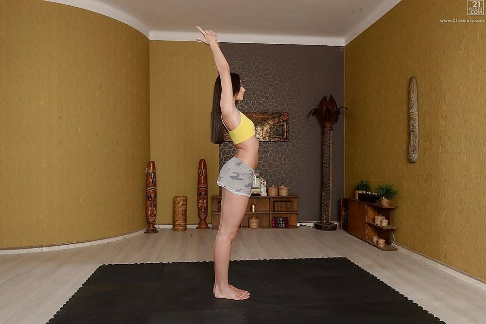 Fully clothed Euro brunette Aruna Aghora doing yoga in barefeet and shorts - #2