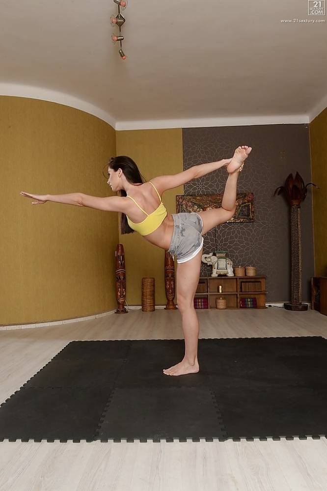 Fully clothed Euro brunette Aruna Aghora doing yoga in barefeet and shorts - #16