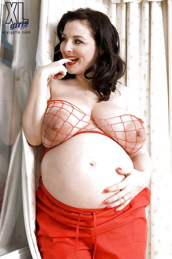 Brunette preggo with fat tits Lorna Morgan posing in fishnet bra and black panties | Photo: 620656
