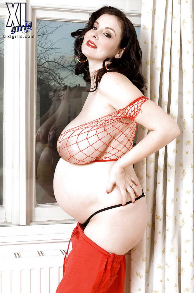Brunette preggo with fat tits Lorna Morgan posing in fishnet bra and black panties | Photo: 620659