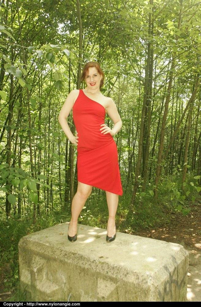 Redhead amateur casts off a red dress to pose nude in tan nylons and heels - #12