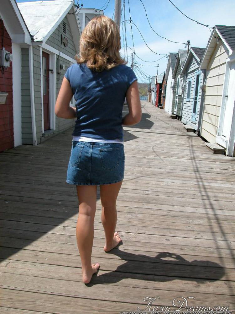 Blonde solo girl flashes upskirt panties on lakeside boardwalk | Photo: 664137