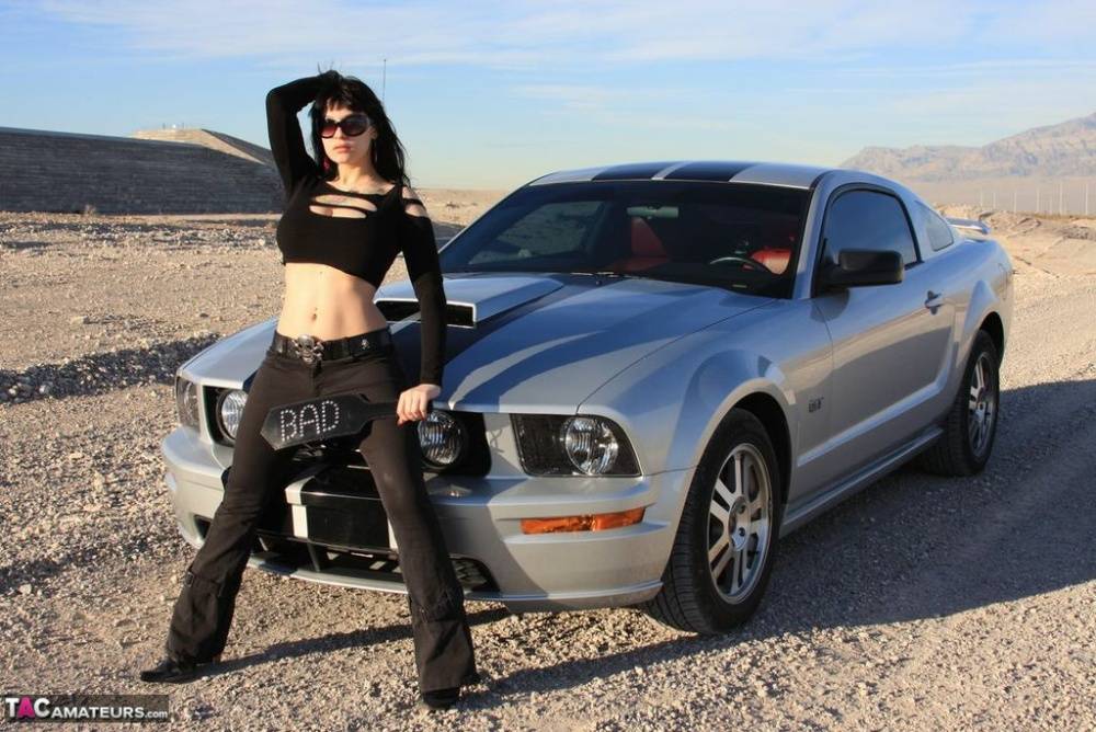 Sexy chick Susy Rocks exposes her bra over the hood of a car in shades | Photo: 673279