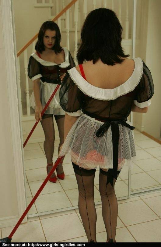Brunette babe in stockings and maid uniform posing in front of the mirror - #1