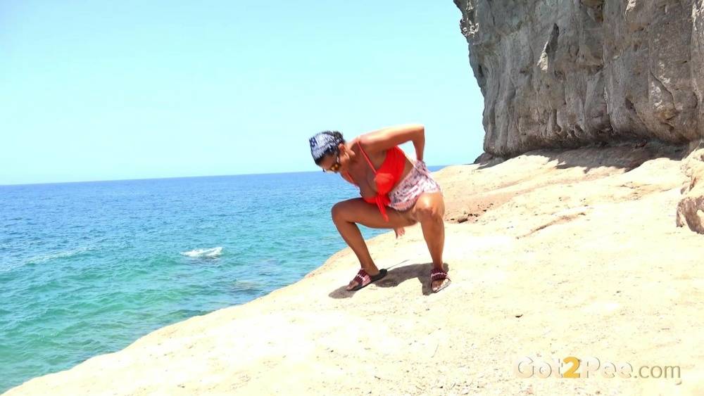 Caucasian girl Chloe Lamour takes a piss while walking upon a seaside cliff - #11