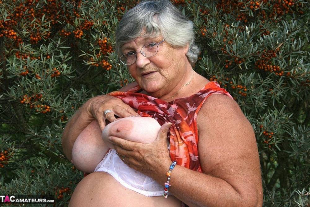 Obese nan Grandma Libby strips totally naked out by evergreen trees | Photo: 793405