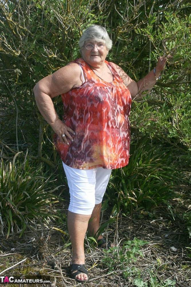 Obese nan Grandma Libby strips totally naked out by evergreen trees - #2