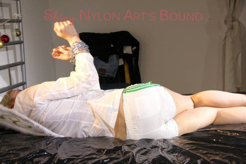 Pia tied and gagged on a bed with cuffs wearing a sexy white shiny nylon - #7
