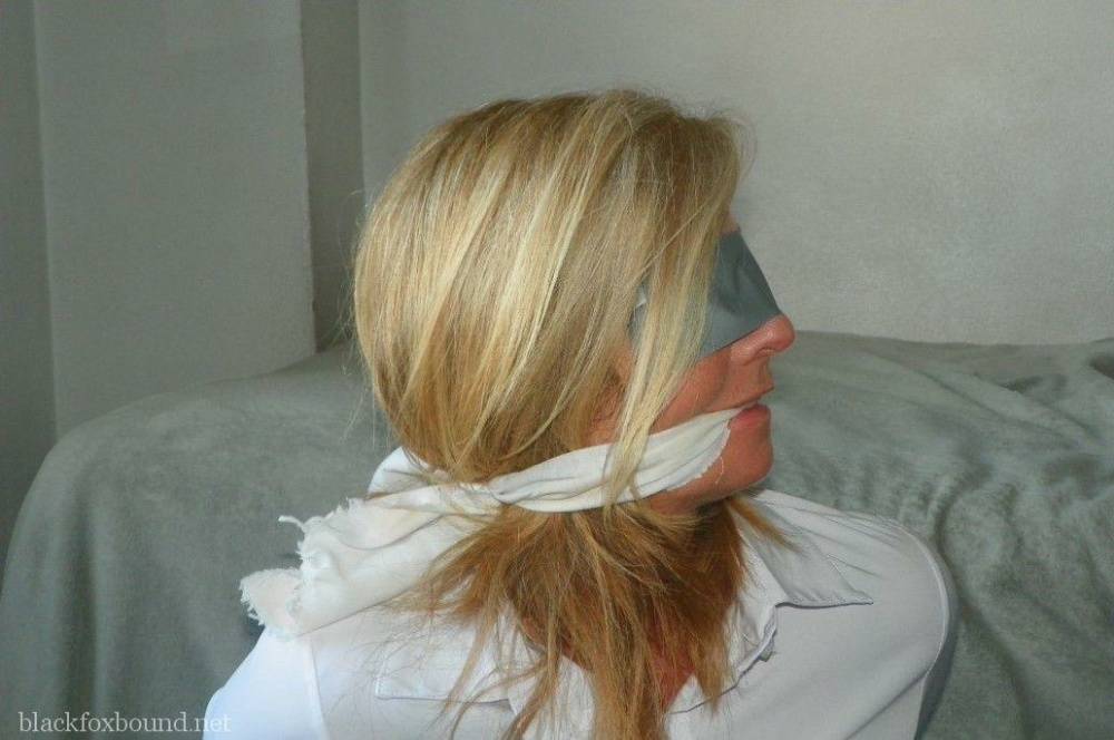 Blonde woman is cleave gagged and hogtied in a white blouse and blue jeans - #15