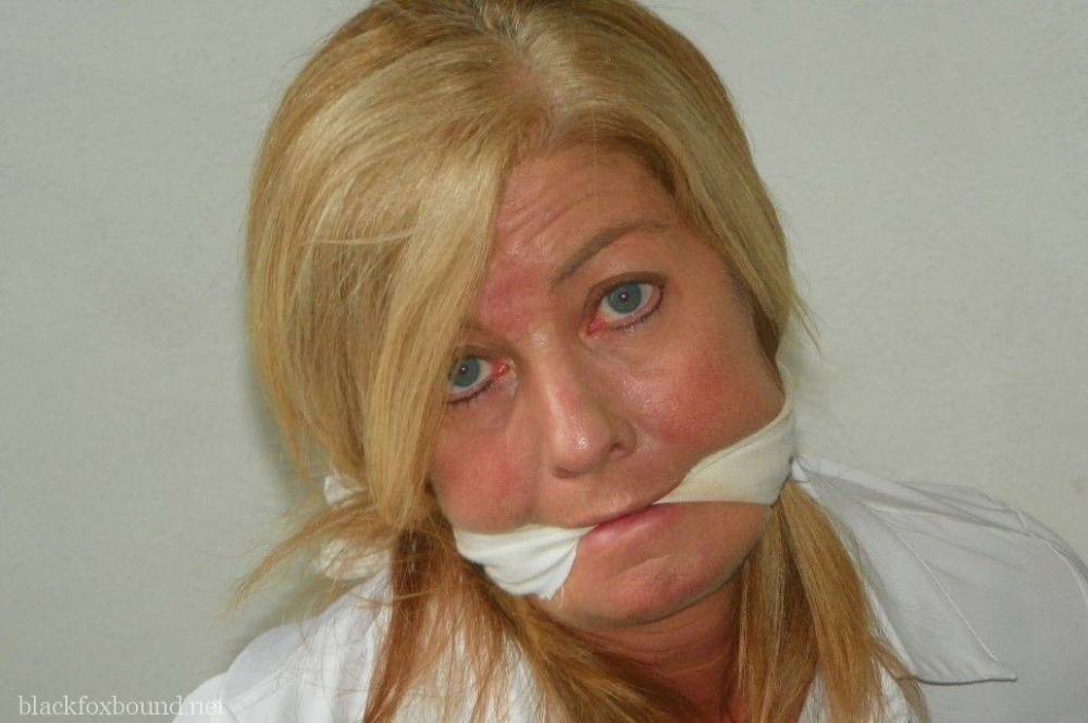 Blonde woman is cleave gagged and hogtied in a white blouse and blue jeans - #1
