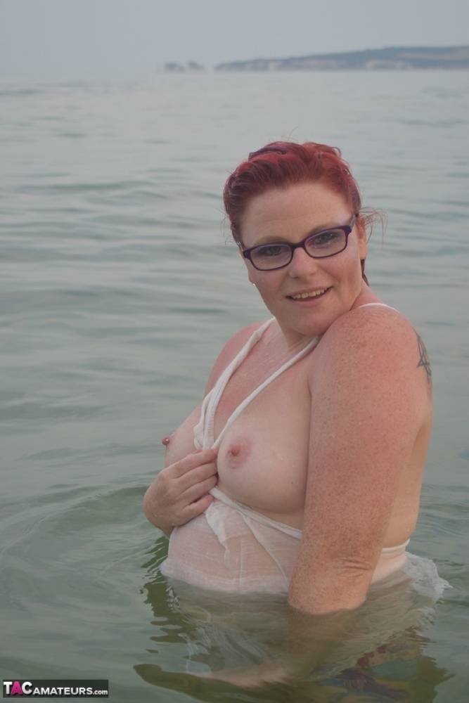 Tattooed redhead poses nude on a beach before masturbating on a toilet seat - #4