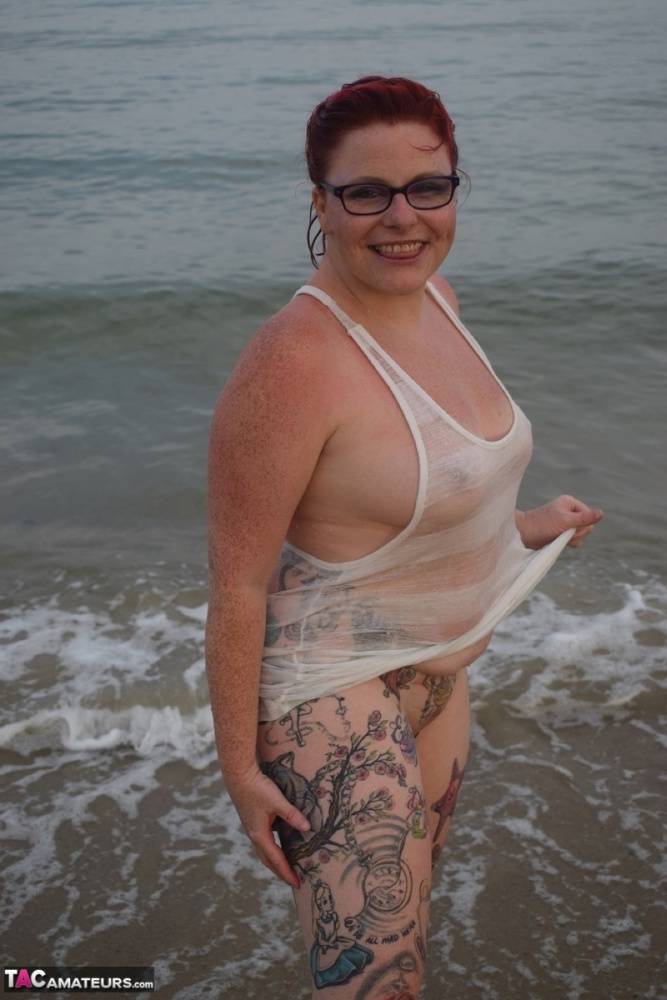 Tattooed redhead poses nude on a beach before masturbating on a toilet seat - #12