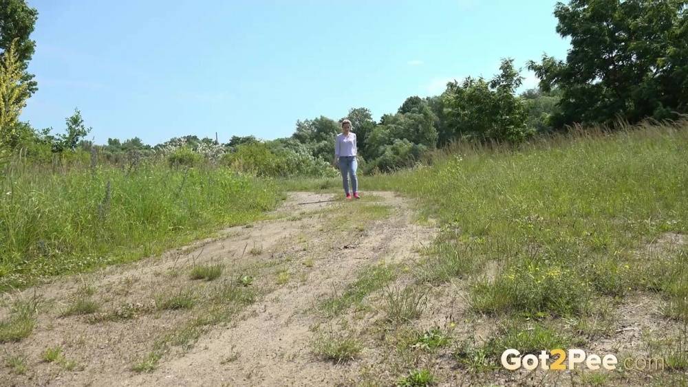 Caucasian girl Di Devi pulls down her pants to take a pee on a dirt road - #6