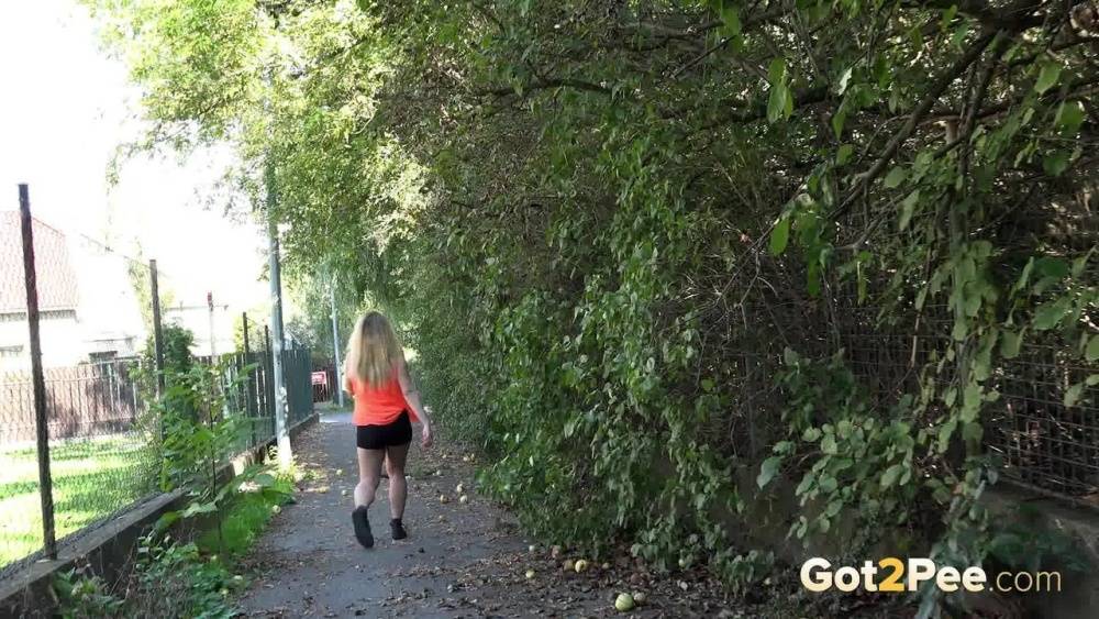 White girl Loreen exposes her bald twat while squatting for a pee in the woods - #1