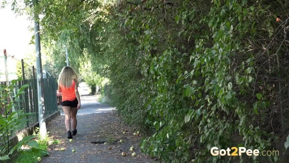 White girl Loreen exposes her bald twat while squatting for a pee in the woods - #4