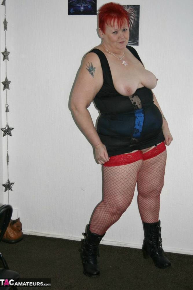Mature BBW in red fishnet stockings & girdle spreading with big tits exposed - #15