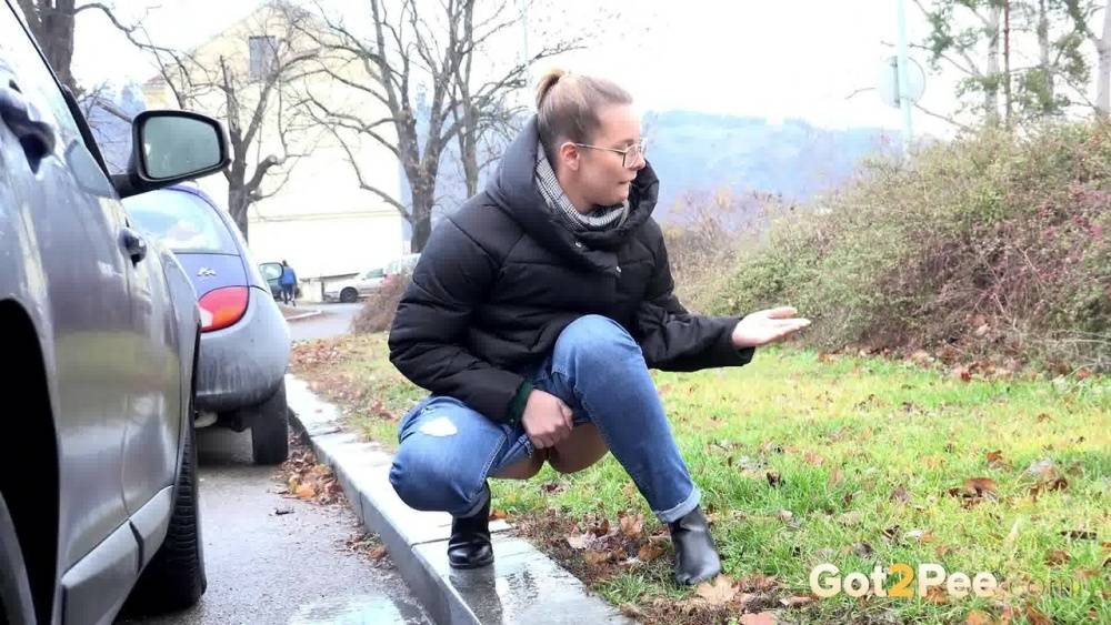Blonde chick Nikki Dream squats for a pee behind vehicles on a road - #6