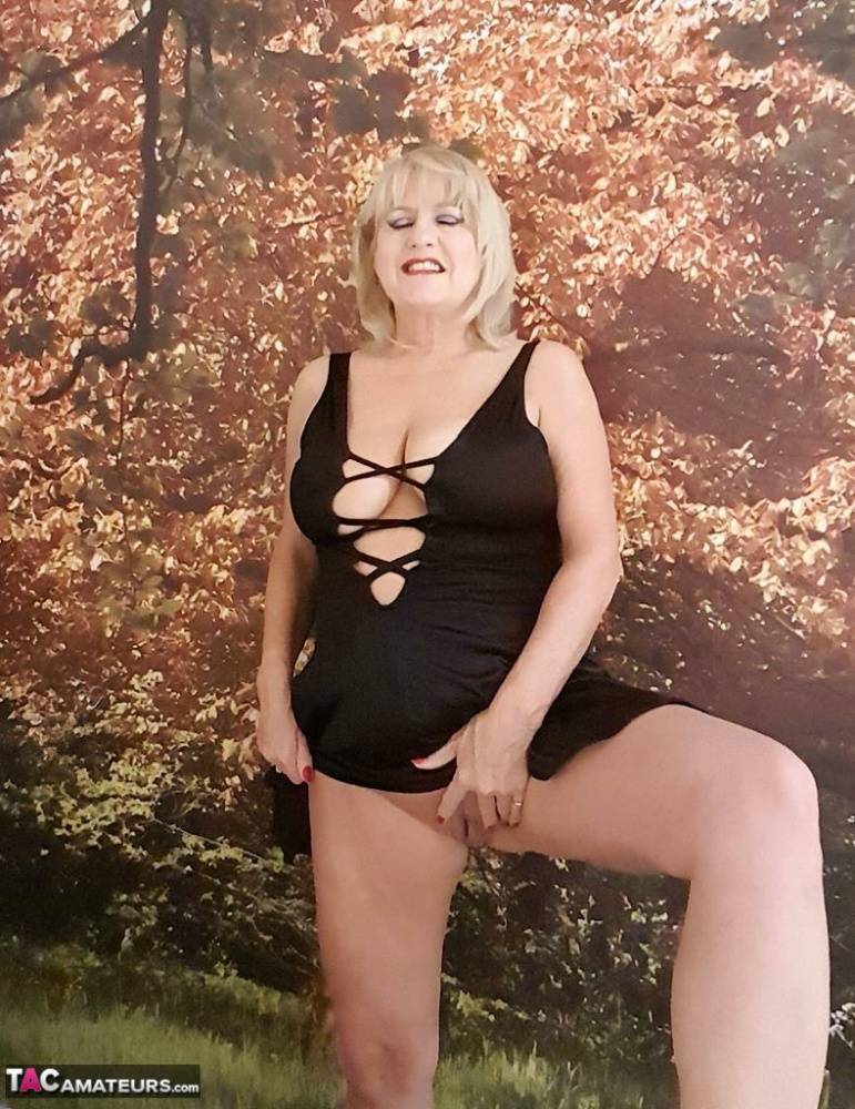 Mature woman frees huge tits from black lingerie before masturbating on bed - #6