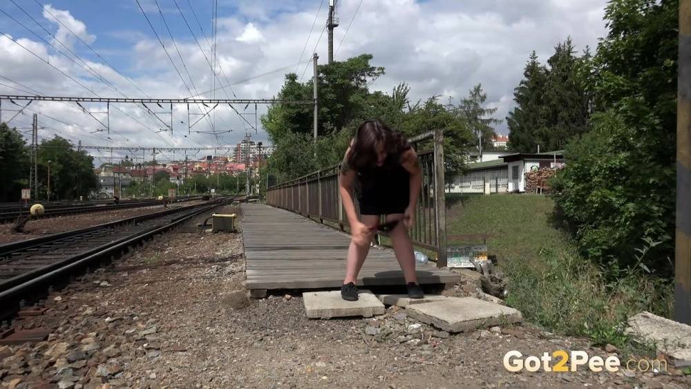 Thick woman Samy squats for a piss at the end of a railway station platform - #12