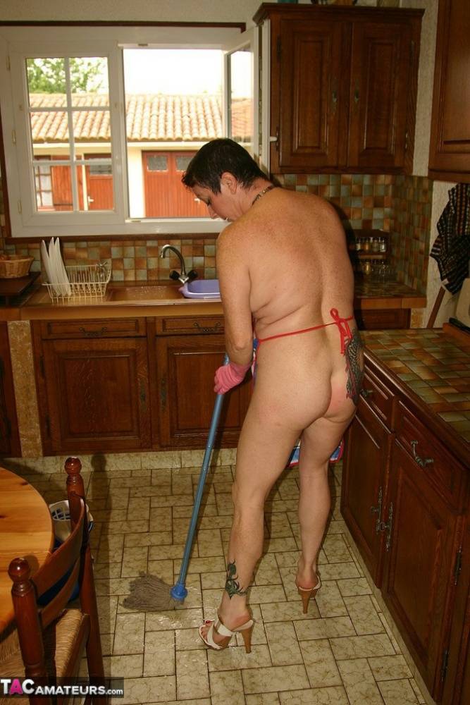 Big titted mature woman Mary Bitch masturbates while cleaning up her kitchen | Photo: 1346599