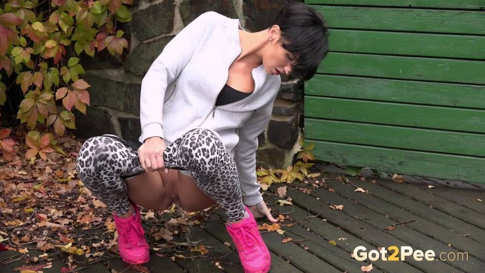 Short haired female Gabriellla Gucci squats for a pee on a deck - #15