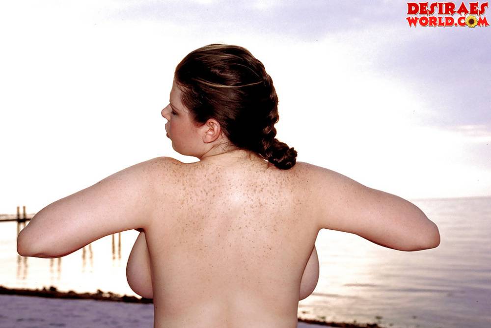 Plump pornstar Desirae demonstrating massive saggy boobs outdoors on beach - #13
