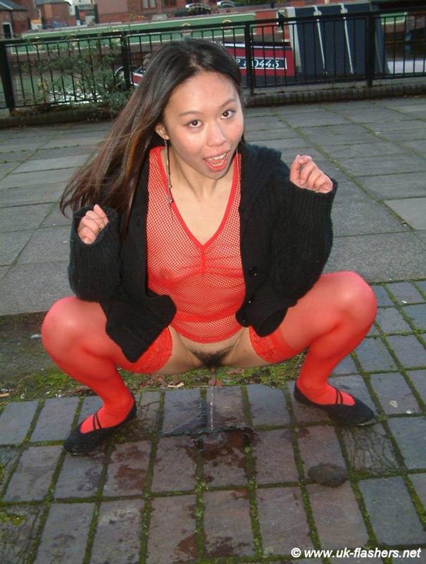 Asian chick squats for a piss while on a public street in England - #4
