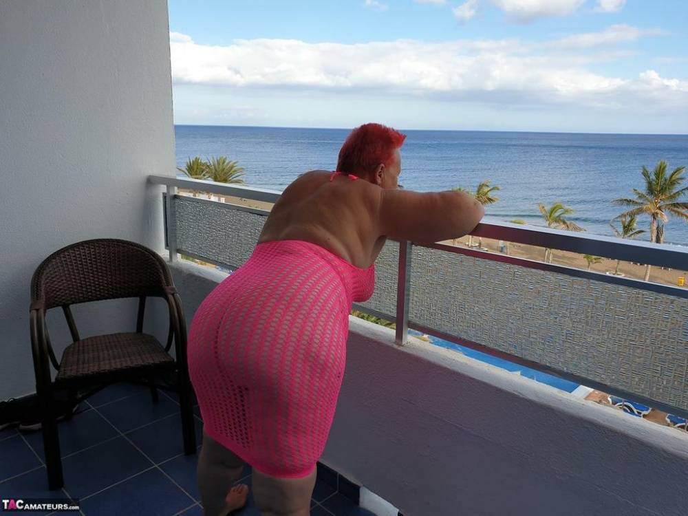 Fat nan with short red hair finger spreads her pussy on oceanside balcony - #16