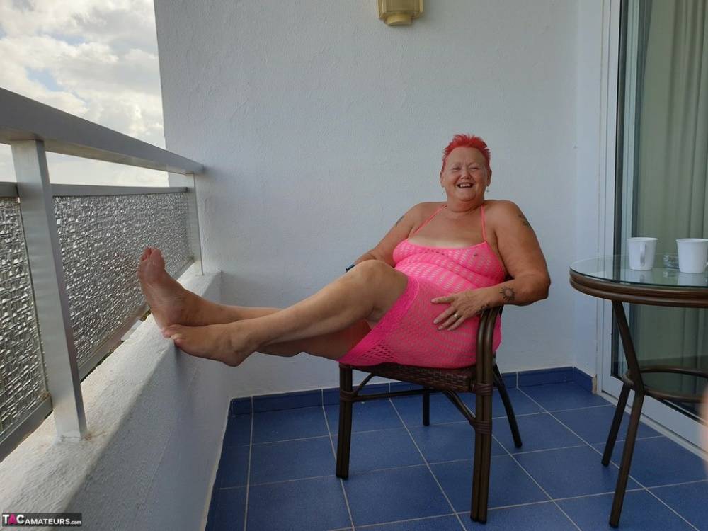 Fat nan with short red hair finger spreads her pussy on oceanside balcony - #9