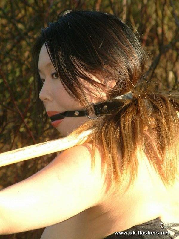 Busty Asian chick is restrained with spreader bar while ballgagged outdoors - #5