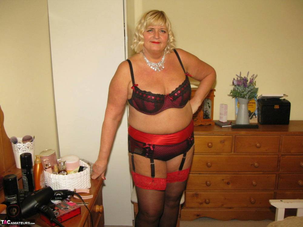 Older blonde fatty Chrissy Uk parts her labia lips on a chair in her bedroom | Photo: 1462493