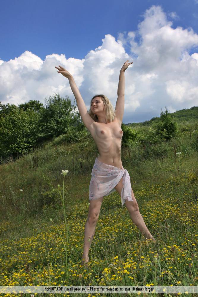 Flexible blonde teen Thea C juggles while completely naked in a field - #7