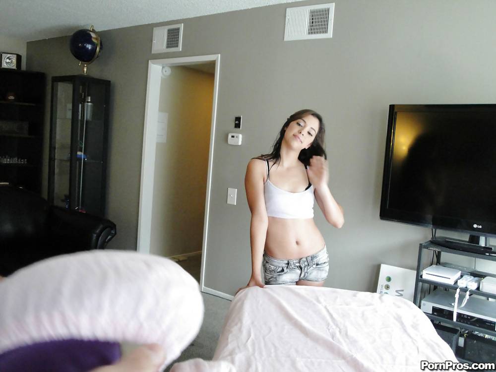 Latina Gigi Rivera stripping off shorts before getting naked on massage table | Photo: 1469559