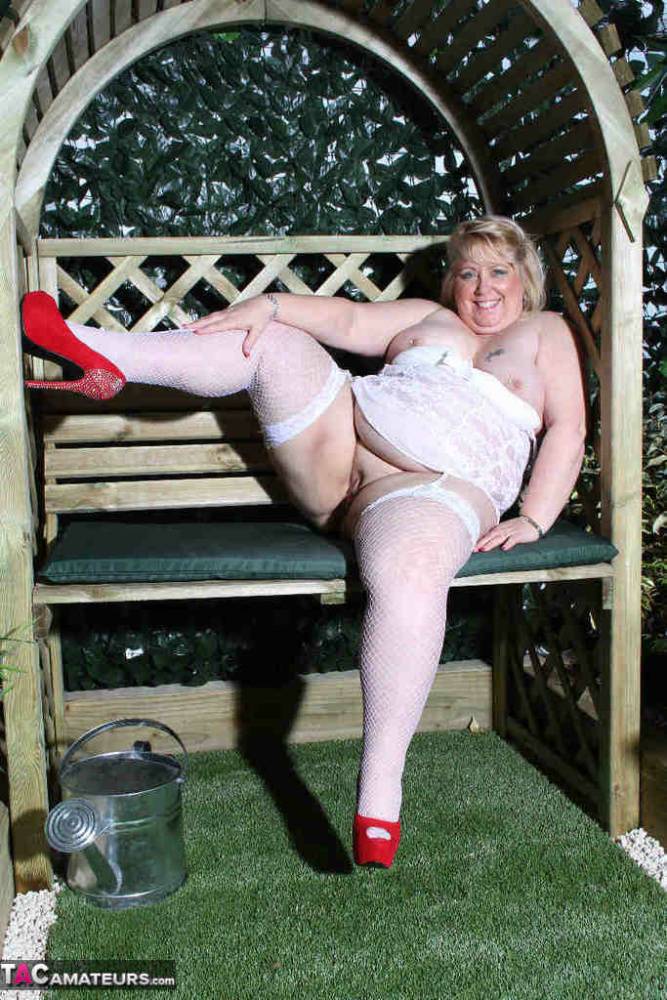 Fat blonde Lexie Cummings dildos her pierced pussy in a garden setting - #11