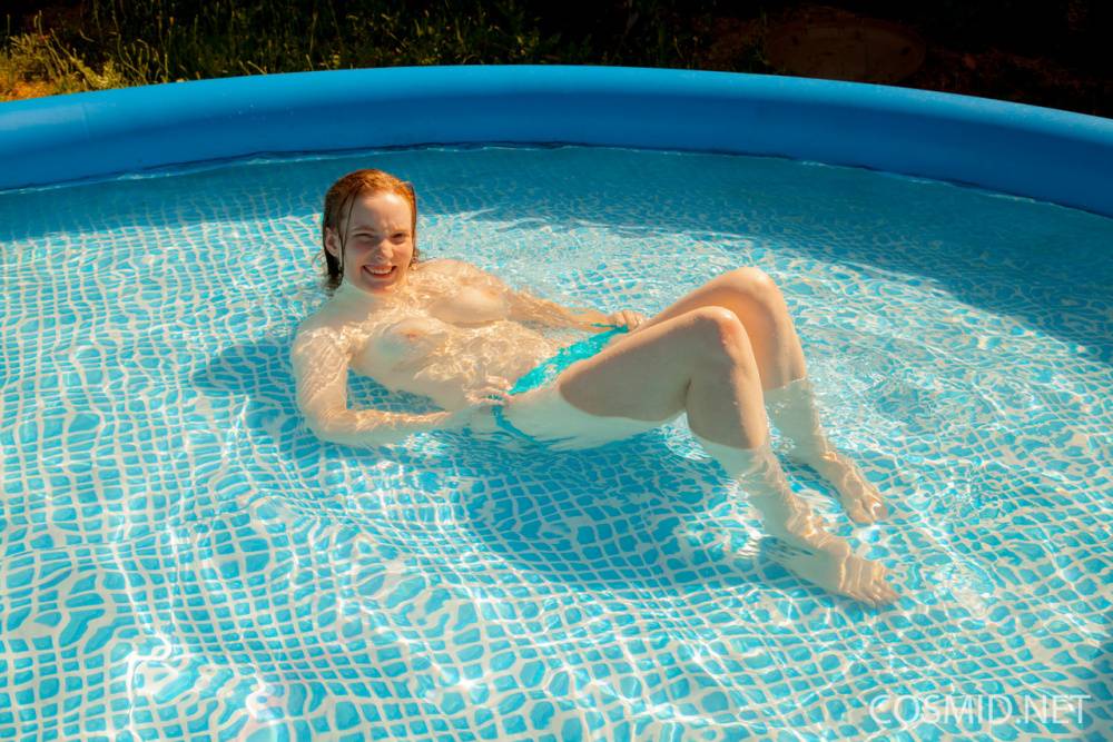 Natural redhead Julia Fleming frees her big natural tits in above ground pool - #6