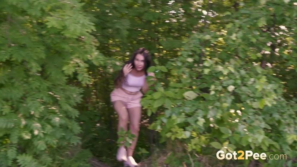 Brunette girl Sasha S emerges from the woods to take a piss on a patch of dirt - #7