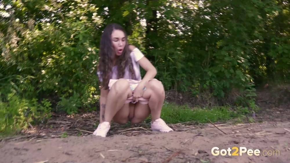 Brunette girl Sasha S emerges from the woods to take a piss on a patch of dirt - #6