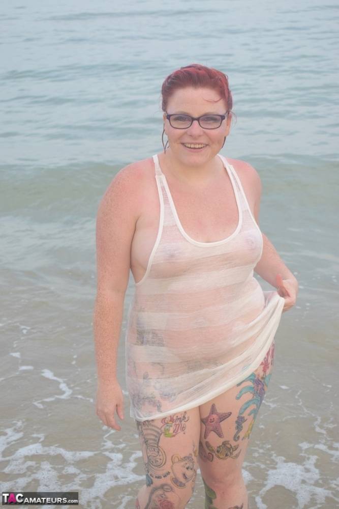 Tattooed redhead wades into the ocean before exposing herself - #11