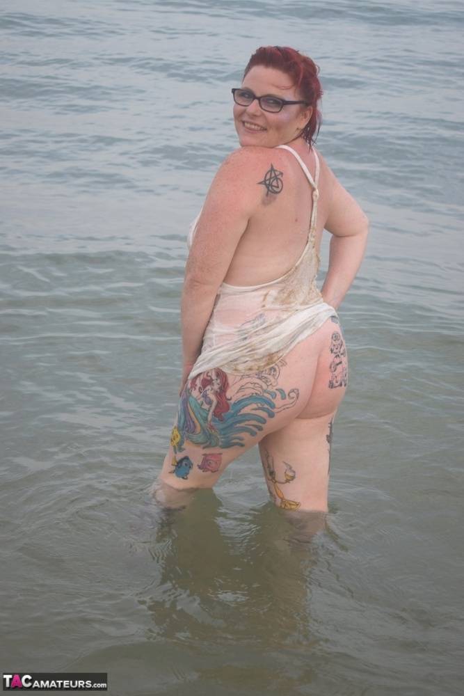 Tattooed redhead wades into the ocean before exposing herself - #1