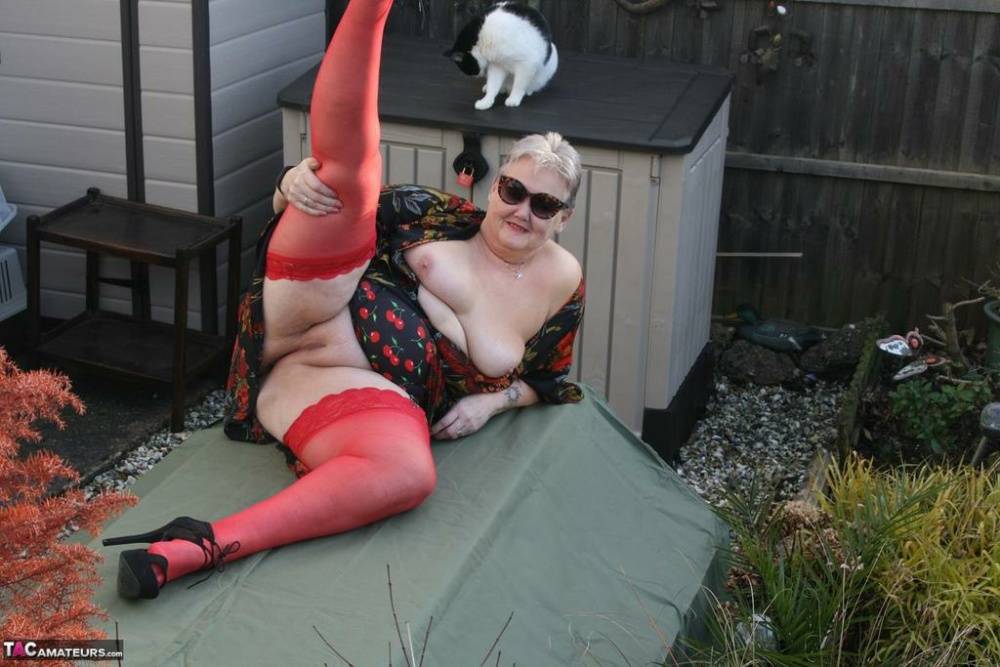 Naughty granny shows her tits and twat in backyard wearing red stockings - #6