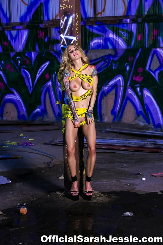 Naked blonde Sarah Jessie works free of police tape while affixed to a post - #9