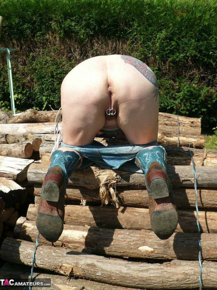 Busty older lady Mary Bitch fingers her cunt on lengths of firewood in boots - #14