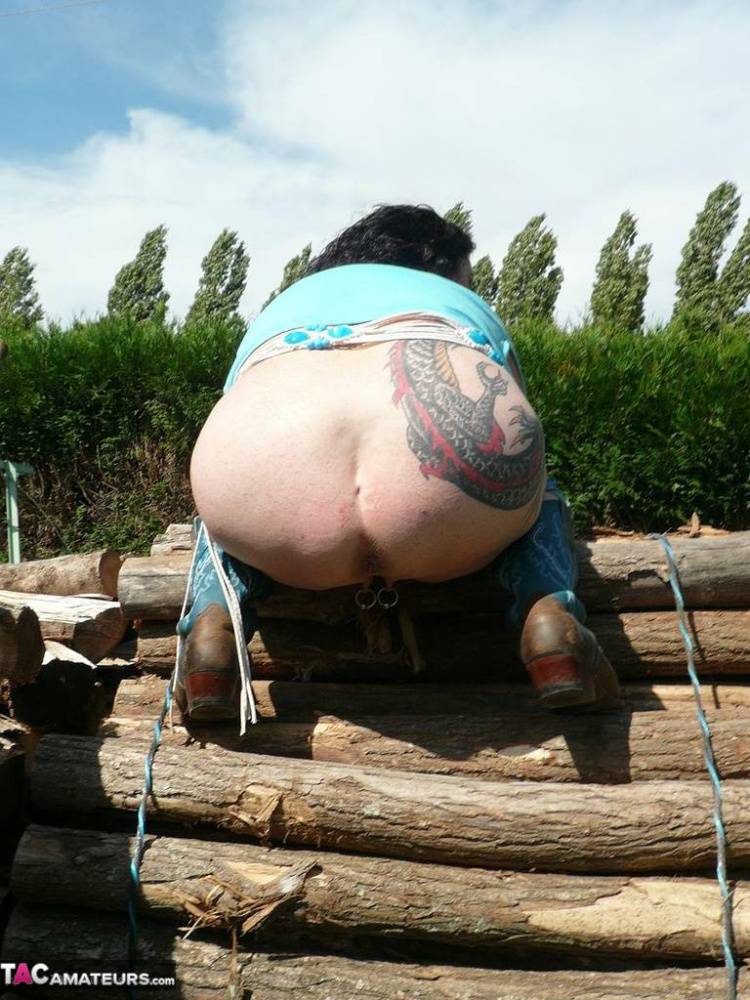 Busty older lady Mary Bitch fingers her cunt on lengths of firewood in boots - #5