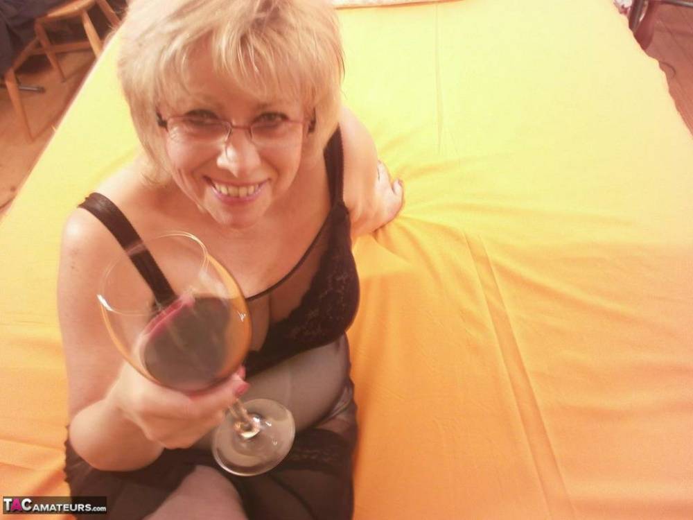 Tipsy hot granny Caro spreading legs on the bed wearing black stockings - #16
