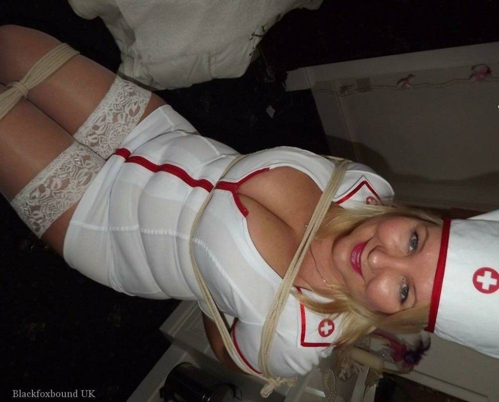 Older blonde with big breasts is tied up in a naughty nurse uniform - #12